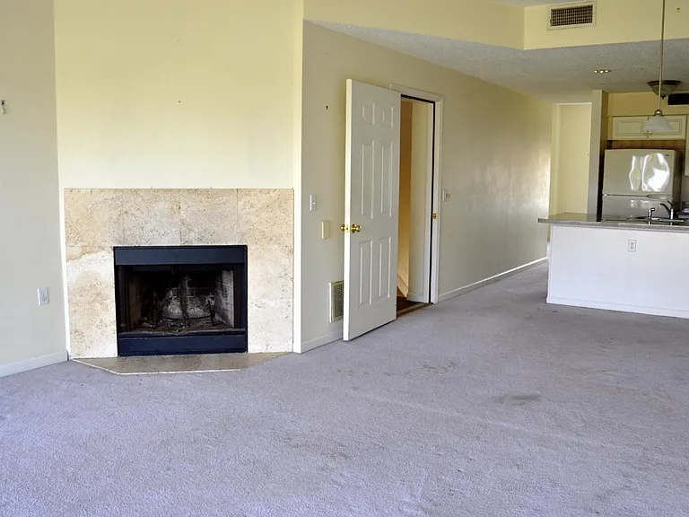 Living room with fireplace.
Also has ocean view and screened porch. Open dining and kitchen.
