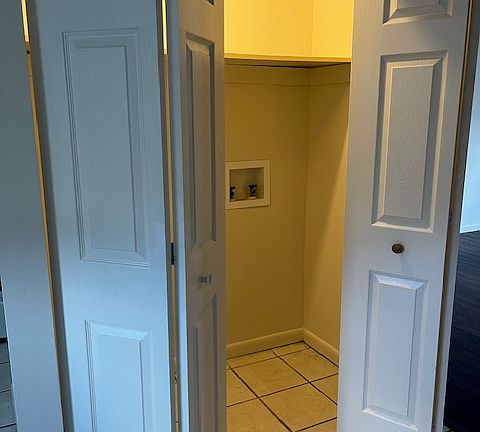 Enclosed laundry area with washer/dryer hookups by the kitchen