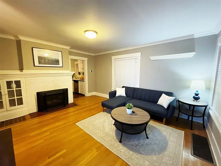 Spacious & cozy main living room with sleeper couch & fire place. Picture taken at night, but good sun light during the day with 2 big windows.