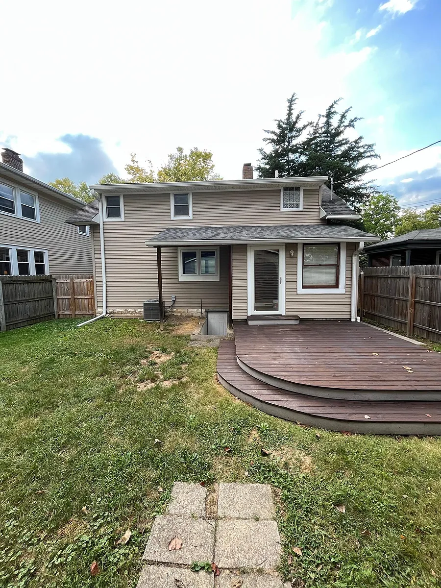 Back of house. Large deck - 5131 N College Ave