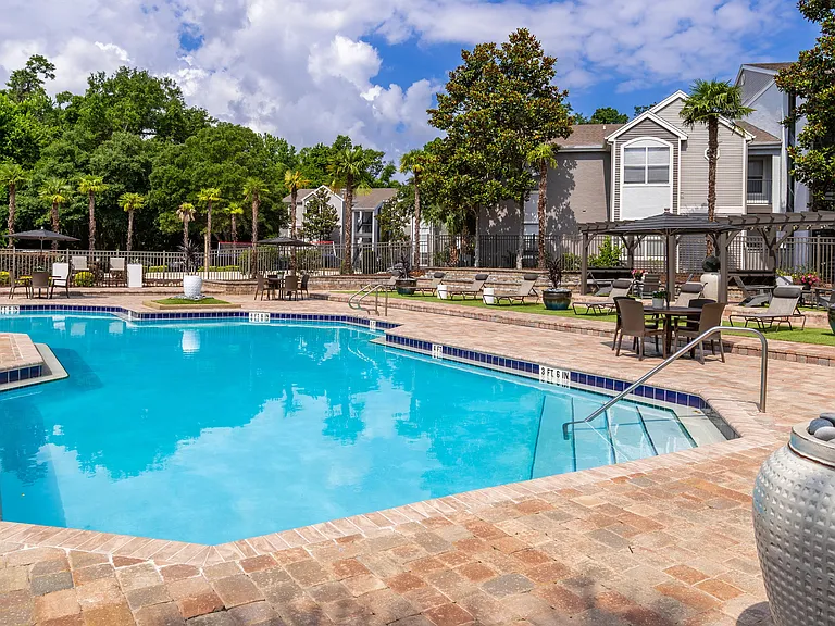Dive into relaxation with our sparkling swimming pool, complete with shaded pergolas, lounge seating, and lush landscaping that brings the resort vibe home.