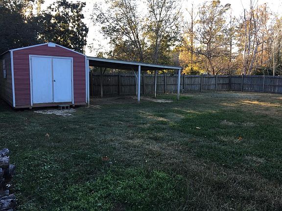 Storage shed & cover in back yard