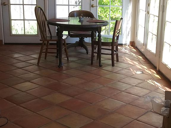 The sun room with three sets of opening doors to the patio.