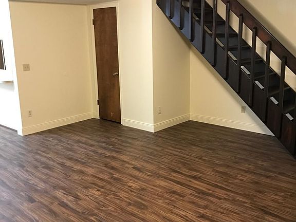 Renovated open plan living room and dining with beautiful staircase