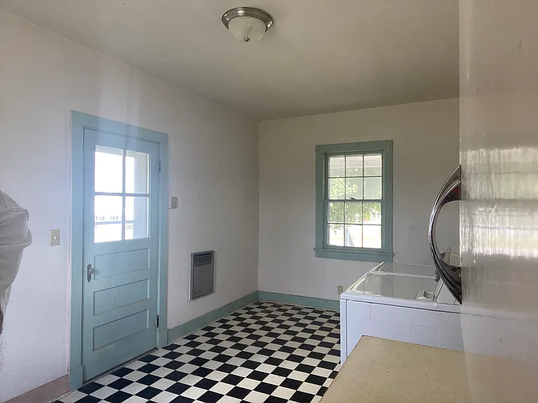 Kitchen looking at side entry and window to front porch
