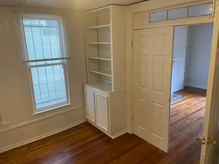 Living room next to kitchen with built in cabinets adjoining kitchen and tv room