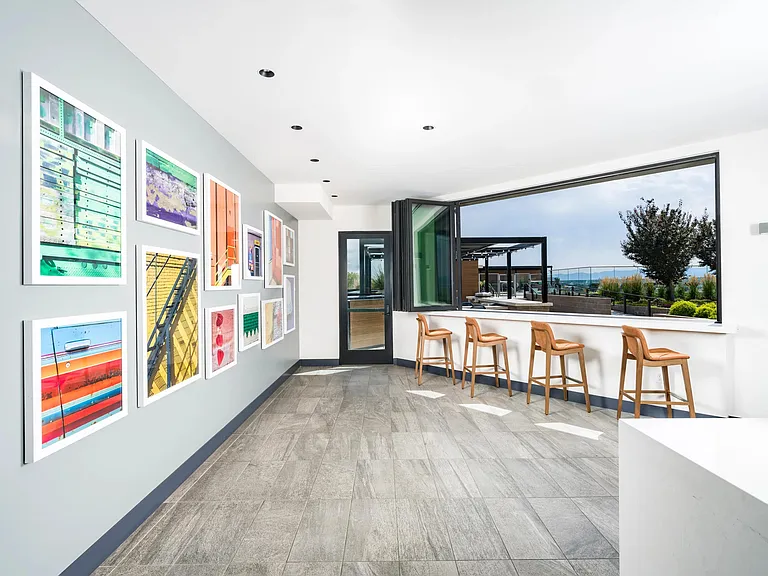 Bright and colorful details lead to the rooftop deck, with open-air bar seating and sweeping mountain views.