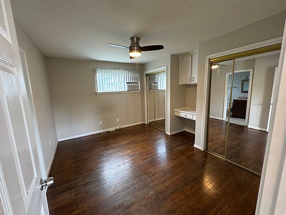 Real hardwood floors in the bedroom. Note: two separate closets and a built-in desk with storage.