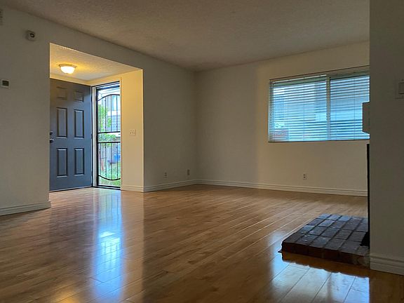 Front door, living room, decorative fireplace.