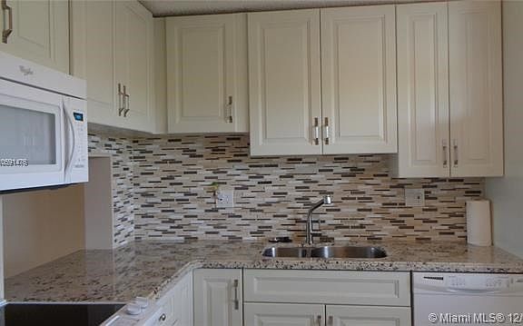 SINK, DISHWASHER, CABINETS TO CEILING