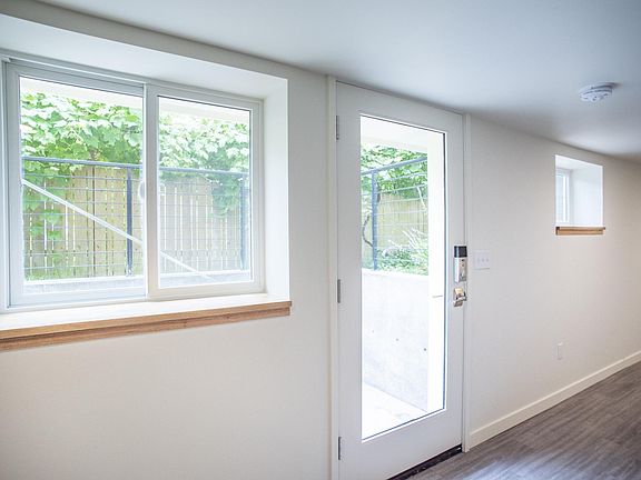 Side yard entry with steps to front door. Small outdoor area with new landscaping to be completed in August.