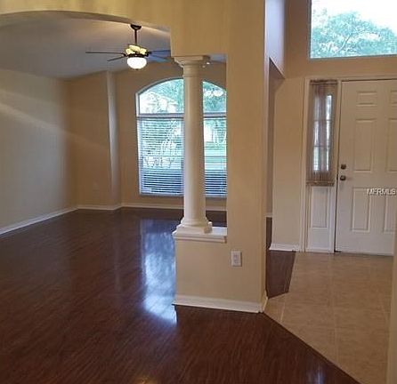 Formal living/dining room combo with beautiful arches and columns.