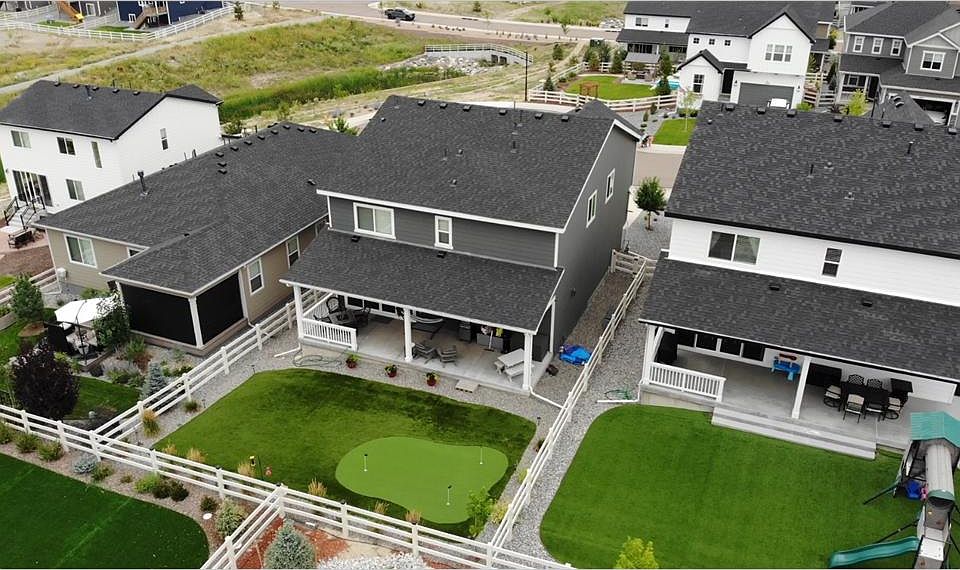 Rear view turf and putting green with full size patio