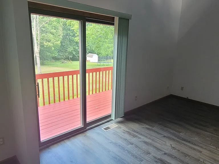 Looking from the dining room is the balcony and living room.