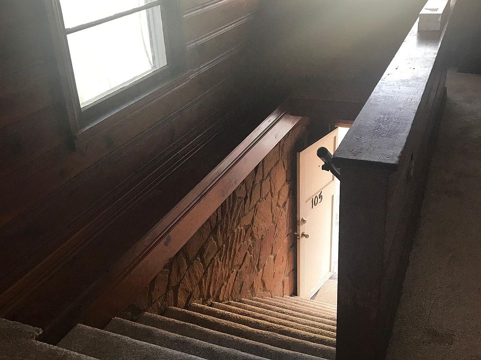 Entry stairs with rock wall and plenty of natural light from