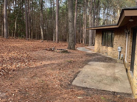 Back of house with fire pit.