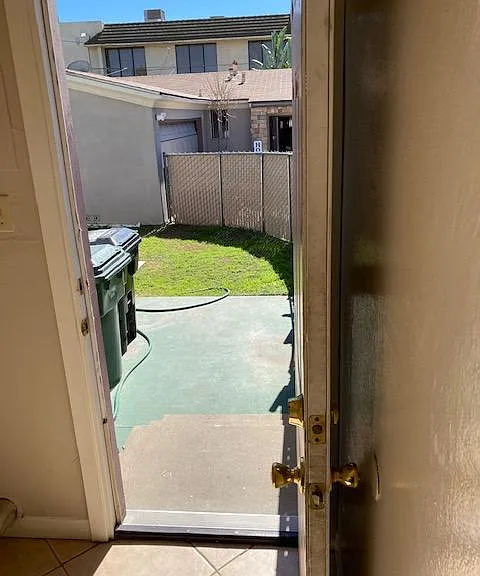 Generous, fenced back yard with lawn, landscaping, and patio.