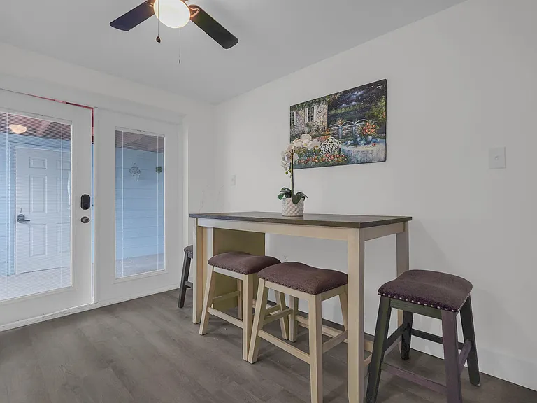Dedicated dining nook with a pub-height table, bar seating, and easy access to the patio door for indoor-outdoor meals.