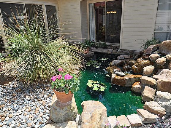 LANDSCAPING PERFECTION WITH A KOI POND AND ROCK WATERFALL