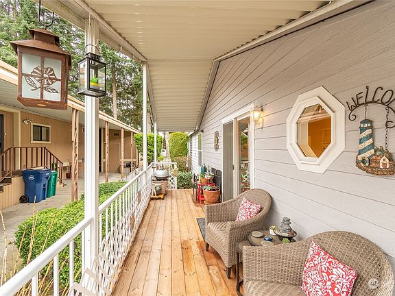 Covered deck with newer wood deck. Two sliding doors off deck, one into living room the other one into master suite.>