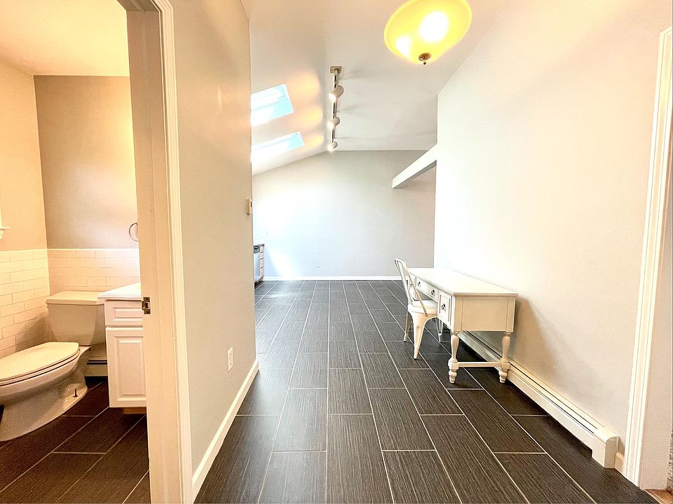 Entry with high ceilings, porcelain floors guiding you throughout the apartment