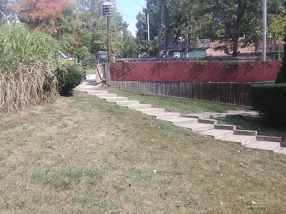 Front yard and parking for 4 inside maroon fence