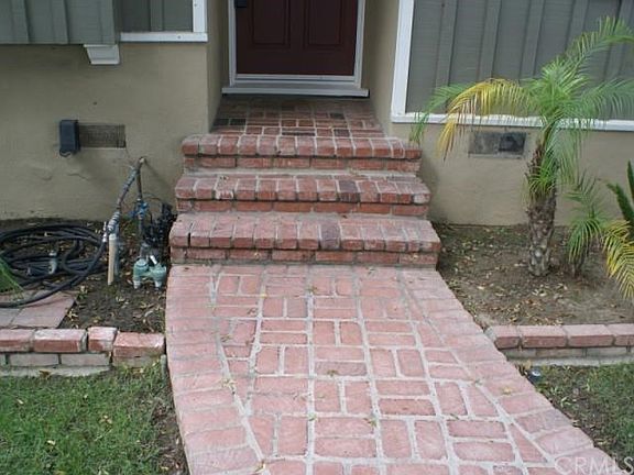 Welcome home!  Red brick walkway and automatic sprinklers.