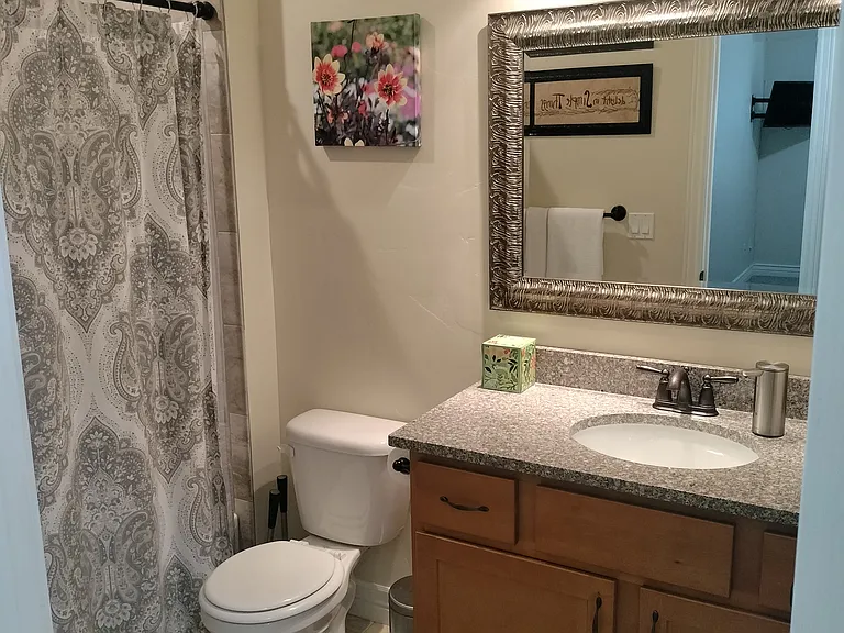 Two inviting guest bedrooms feature Smart TVs and convenient touch lighting, offering comfort and modern amenities for a relaxing stay. Perfect for unwinding and enjoying a restful night.