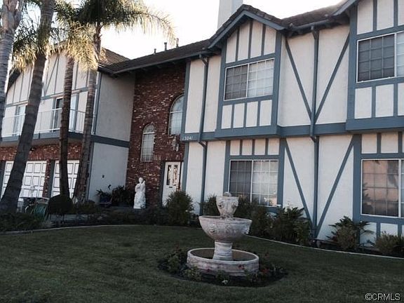 Sideview of home front, with fountain and landscaping