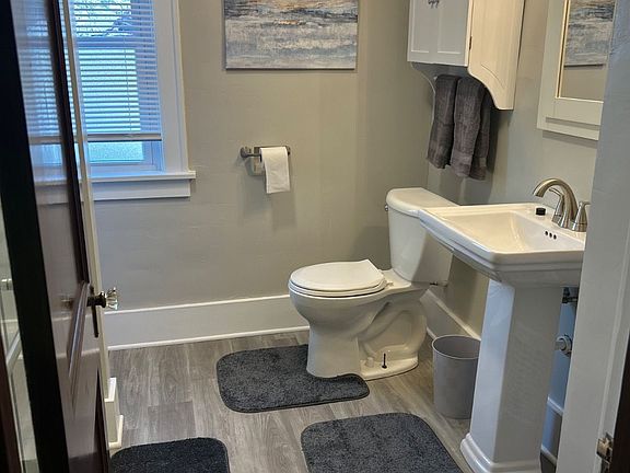 Completely renovated bathroom with new shower and vanity. Extra storage is also provided with a ladder shelf near the shower.