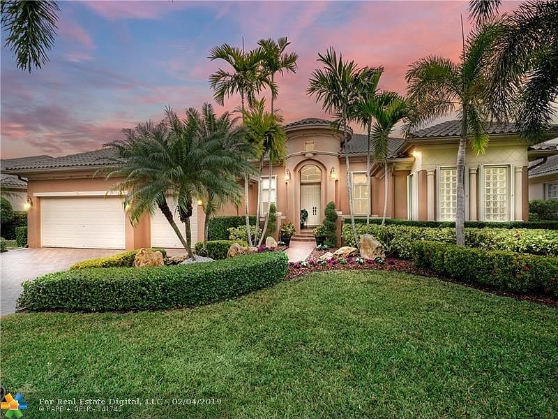 Beautiful curb appeal with tropical landscaping