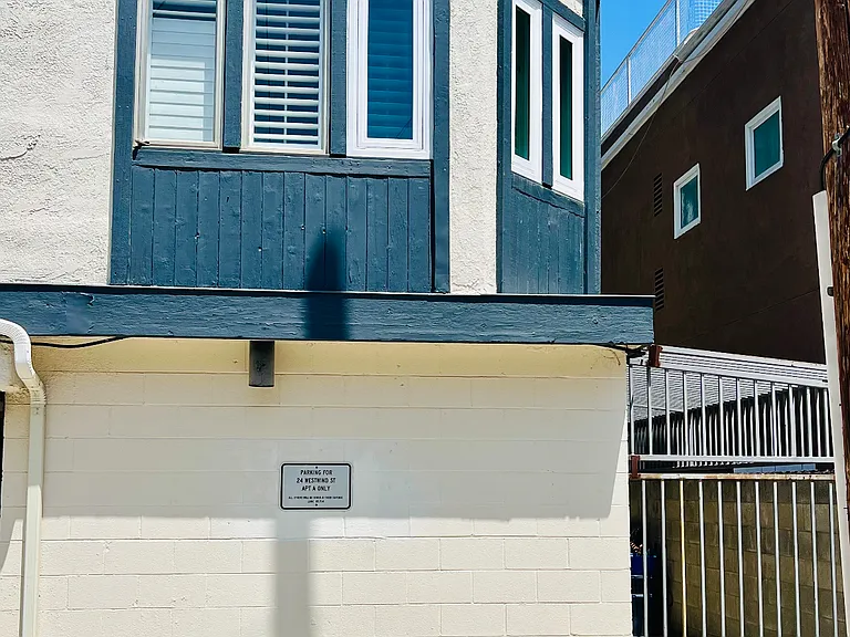 This is the back of the house--you can see the off-street parking spot, just below the windows of the condo that's for rent.