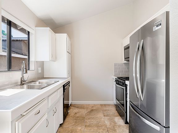 Sunny and bright kitchen with new French door refrigerator and new microwave