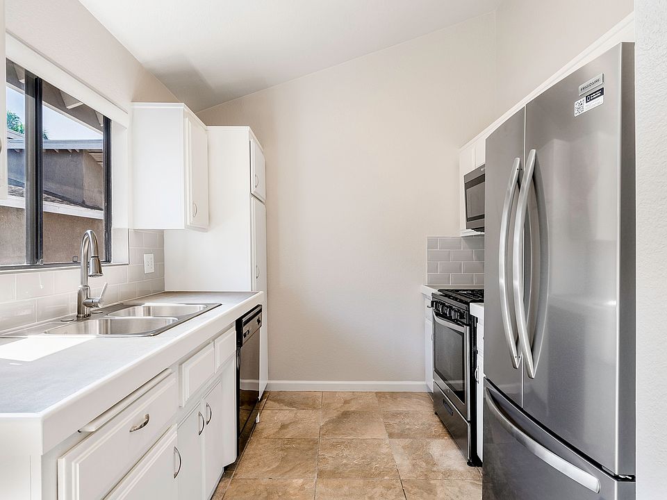 Sunny and bright kitchen with new French door refrigerator and new microwave