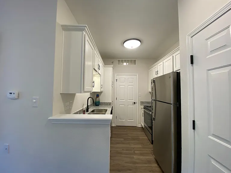 The galley-style kitchen makes cooking efficient with a functional layout and modern appliances.