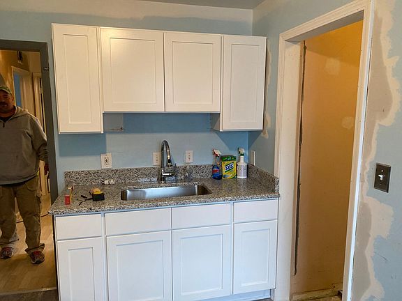 Brand New Kitchen with new cabinets, granite countertop, and laminate floor