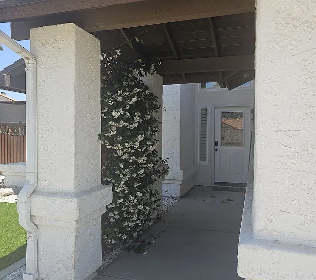 Shaded front entrance fragrantly enhanced with Jasmine.
