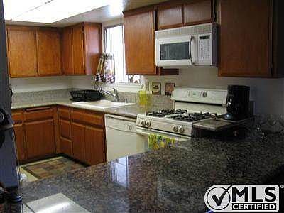 Kitchen with granite countertops for prepping and eating.