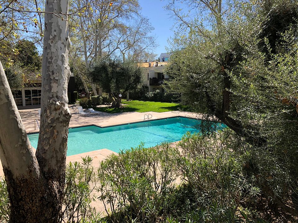 Balcony overlooking pool and grass.
