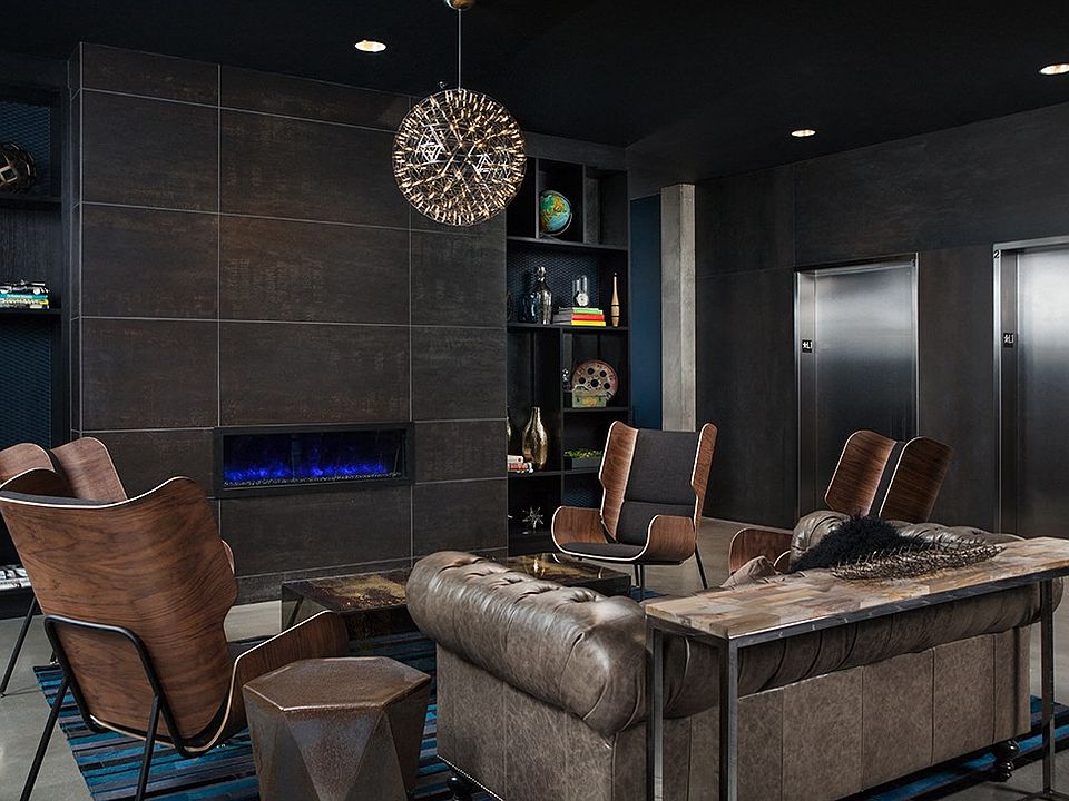 Stylish Resident Lounge with Leather Seating and Modern Fireplace at Pike Motorworks