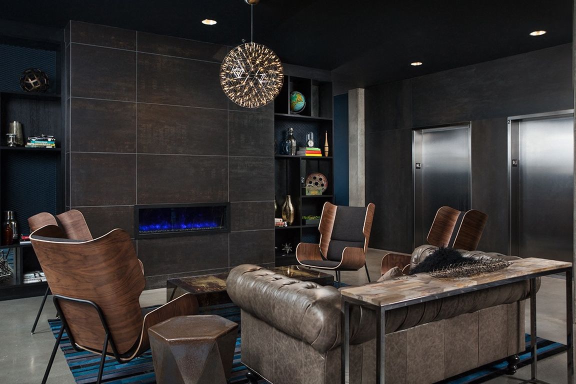 Stylish Resident Lounge with Leather Seating and Modern Fireplace at Pike Motorworks