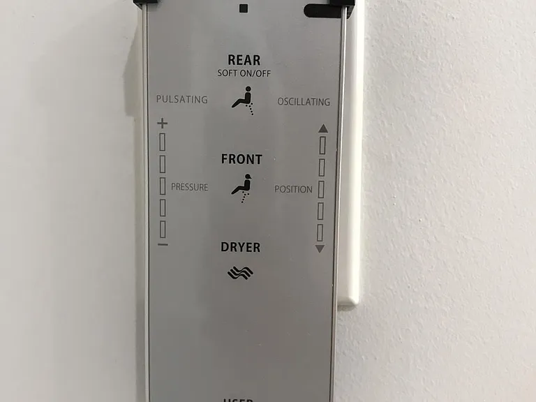 Toilet's wireless controls with bidet wash, water temperature controls, dryer, and seat warmer.