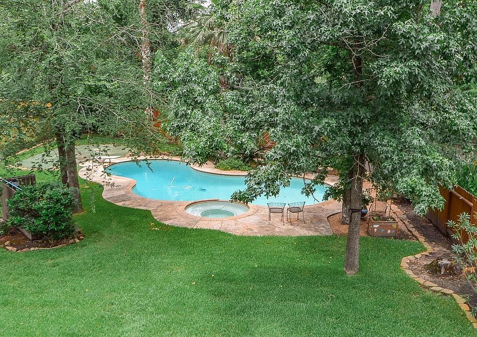 The balcony off of one of the bedrooms provides this lovely vista from high above. Imagine morning coffee on your porch looking onto your gorgeous piece of heaven. Sit and relax, go down for a swim. There's still plenty of green space for the kids or