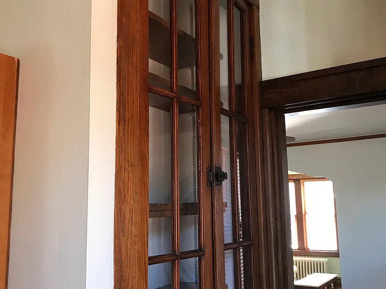 Original China Cabinet between kitchen-dining room. One of 2 means of access into kitchen-dining room