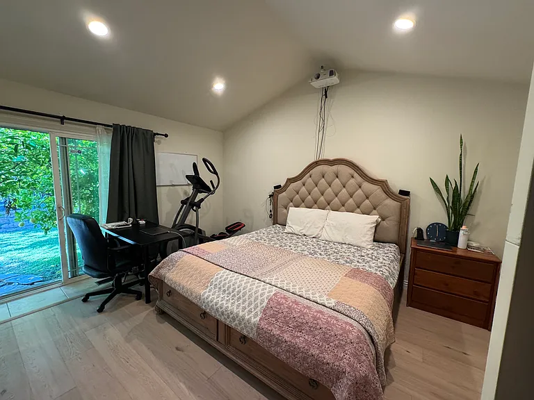 Master bedroom with backyard access, vaulted ceiling & recessed lights