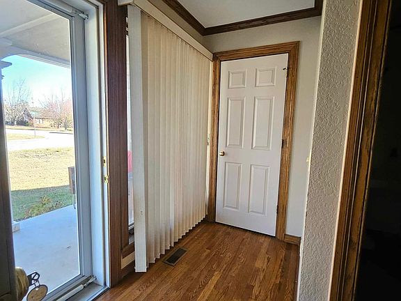 Front entry with storage closet and half bath on the right