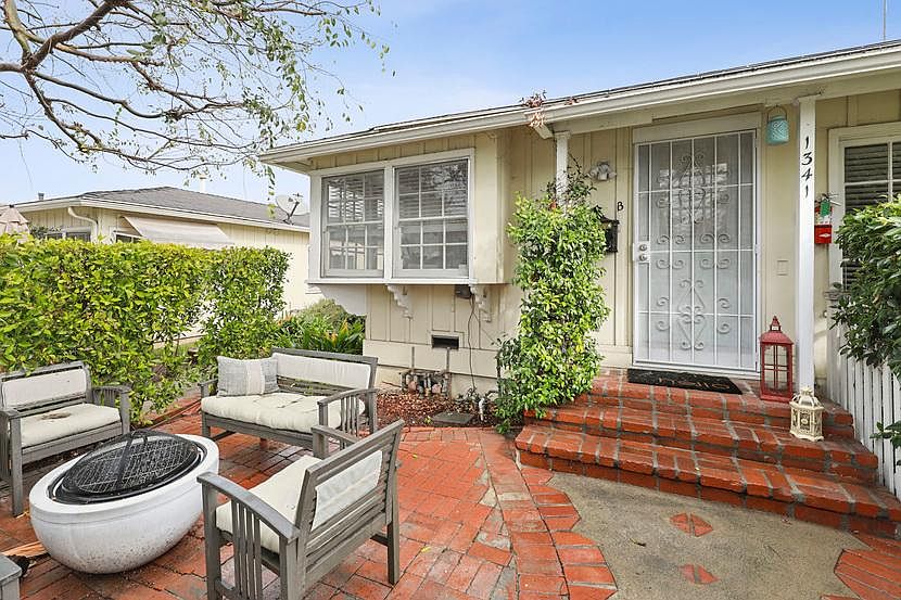 Front of unit with the private garden patio. *Outdoor furniture & firepit not included.