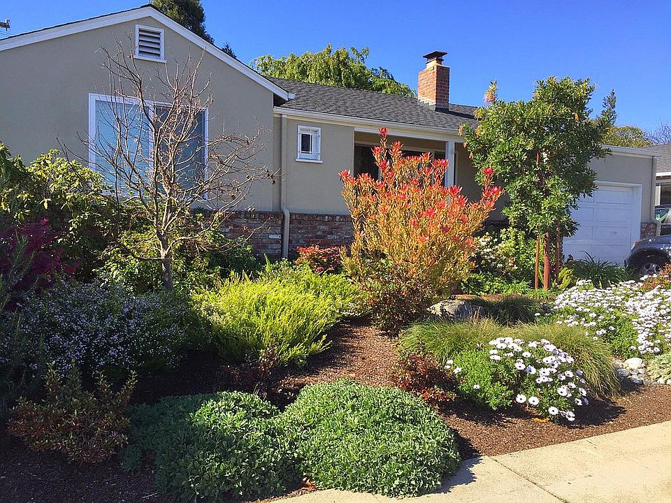 Front of house with a no-maintenance, well-manicured yard on a drip system. The house is across from the main park, playground and tennis courts with free summer concerts.