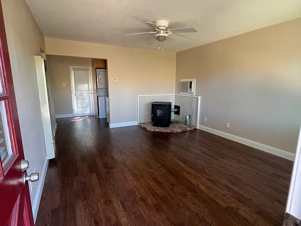 Living room through front door, with pellet stove fireplace .