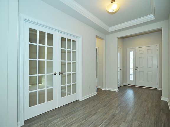 Entry of home. To the left is bedroom 2, bath 2 and home office with french doors